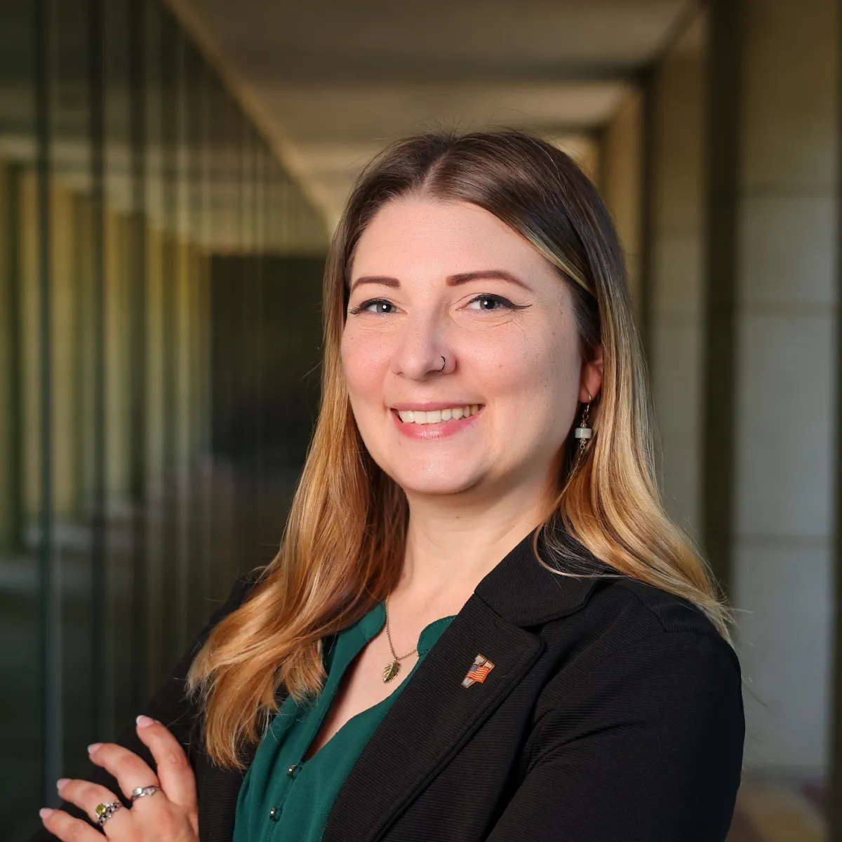 Kat Denson headshot with her arms crossed